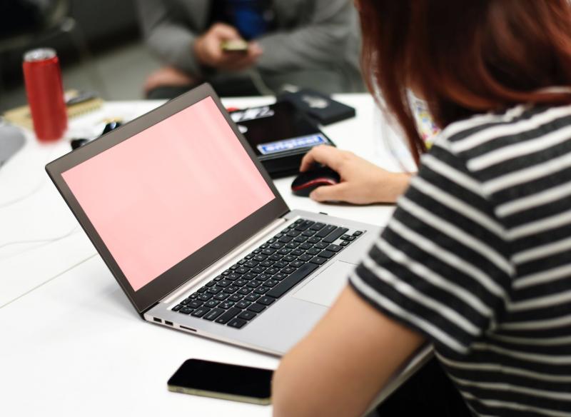 girl on laptop with pink screen